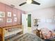 Cozy bedroom featuring a crib, plush rug, and stylish decor at 4435 Lamson Ave, Spring Hill, FL 34608