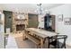 Open dining room features a stone fireplace and contemporary light fixture at 4435 Lamson Ave, Spring Hill, FL 34608