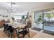 Open concept dining room flowing to outdoor space and a modern living area at 4435 Lamson Ave, Spring Hill, FL 34608
