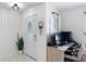 Bright foyer area with white door, leading to a room with a desk at 4435 Lamson Ave, Spring Hill, FL 34608