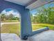 Arched porch entryway featuring muted blue tones, leading to a home with manicured landscaping at 4435 Lamson Ave, Spring Hill, FL 34608