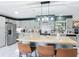 Bright kitchen with stainless appliances, island, and gray cabinetry at 4435 Lamson Ave, Spring Hill, FL 34608