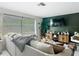 Cozy living room featuring a plush sofa, large window, and modern entertainment center at 4435 Lamson Ave, Spring Hill, FL 34608