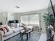 Inviting living area featuring a large sectional couch, window with natural lighting, and an area rug at 4435 Lamson Ave, Spring Hill, FL 34608