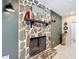 Living room featuring a stone fireplace with a wooden mantel and a mirror above at 4435 Lamson Ave, Spring Hill, FL 34608