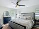 Bright and airy main bedroom with a ceiling fan and a comfortable gray bed at 4435 Lamson Ave, Spring Hill, FL 34608