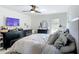 Comfortable main bedroom with a ceiling fan, dresser, and a crib at 4435 Lamson Ave, Spring Hill, FL 34608
