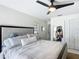Bright main bedroom with a ceiling fan, closet, and comfortable gray bed at 4435 Lamson Ave, Spring Hill, FL 34608
