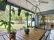 Inviting screened porch featuring hanging potted plants with a ceiling fan at 4435 Lamson Ave, Spring Hill, FL 34608