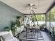 Inviting screened porch featuring a dining table and numerous plants at 4435 Lamson Ave, Spring Hill, FL 34608