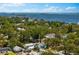 Aerial view of home with waterfront view and lush surrounding trees at 475 Crystal Beach, Crystal Beach, FL 34681