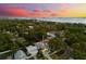 Aerial shot of neighborhood with water views at sunset at 475 Crystal Beach, Crystal Beach, FL 34681