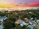 Aerial shot of a neighborhood with waterfront views during sunset at 475 Crystal Beach, Crystal Beach, FL 34681