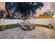Cozy backyard patio with stone pavers, outdoor seating, and string lights at sunset at 475 Crystal Beach, Crystal Beach, FL 34681