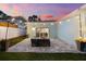 Well-lit backyard with a cozy patio, outdoor seating, and glass sliding doors leading indoors at 475 Crystal Beach, Crystal Beach, FL 34681