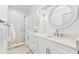 This bathroom is bright and features double sinks, marble countertops, and a walk-in shower at 475 Crystal Beach, Crystal Beach, FL 34681