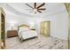 Cozy bedroom featuring tray ceilings, wood-look floors, and vintage-style furnishings at 475 Crystal Beach, Crystal Beach, FL 34681