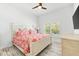 This is a bedroom featuring a stylish bed with printed bedding, a ceiling fan, and natural light at 475 Crystal Beach, Crystal Beach, FL 34681
