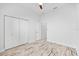 Bright bedroom featuring weathered flooring, ceiling fan, and a double door closet at 475 Crystal Beach, Crystal Beach, FL 34681