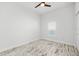 Minimalist bedroom with a ceiling fan, weathered flooring, and natural light from a window at 475 Crystal Beach, Crystal Beach, FL 34681