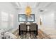 Dining area with modern table, stylish pendant light, and views of shuttered windows at 475 Crystal Beach, Crystal Beach, FL 34681