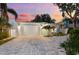 Charming single story home with nicely landscaped yard and brick driveway under a colorful sunset sky at 475 Crystal Beach, Crystal Beach, FL 34681