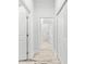 Hallway leading to bathroom with white walls, weathered flooring, and a glass shower at 475 Crystal Beach, Crystal Beach, FL 34681