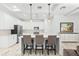 Modern kitchen featuring an island with seating, stainless steel appliances, and stylish pendant lights at 475 Crystal Beach, Crystal Beach, FL 34681
