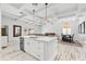 Open-concept kitchen featuring a large island, white cabinets, and views into the dining and living areas at 475 Crystal Beach, Crystal Beach, FL 34681