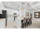 Bright kitchen with white cabinets, marble countertops and island with seating at 475 Crystal Beach, Crystal Beach, FL 34681