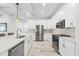 Well-lit kitchen with white distressed floors, a marble counter island, and stainless steel appliances at 475 Crystal Beach, Crystal Beach, FL 34681