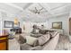Spacious living room featuring a coffered ceiling, dining area and open kitchen at 475 Crystal Beach, Crystal Beach, FL 34681