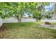 Expansive backyard featuring a well-maintained lawn and a pristine white privacy fence at 4915 Fort Peck Rd, New Port Richey, FL 34655