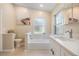 Bathroom showcasing a modern bathtub, toilet, and stylish decor, complemented by neutral tones at 4915 Fort Peck Rd, New Port Richey, FL 34655