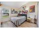 Cozy bedroom with themed wall art, a comfortable bed, and a large window for plenty of natural light at 4915 Fort Peck Rd, New Port Richey, FL 34655