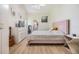 Bedroom featuring light walls, wood floors, decorative headboard, and stylish touches that make a cozy retreat at 4915 Fort Peck Rd, New Port Richey, FL 34655