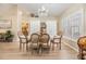 Elegant dining room featuring a chandelier, plantation shutters, and a round table at 4915 Fort Peck Rd, New Port Richey, FL 34655