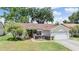 Charming home with a manicured lawn, a two-car garage, and beautiful landscaping, creating excellent curb appeal at 4915 Fort Peck Rd, New Port Richey, FL 34655