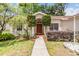 Inviting front entrance with a well-manicured lawn and beautiful landscaping, creating excellent curb appeal at 4915 Fort Peck Rd, New Port Richey, FL 34655