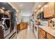 Bright kitchen boasts stainless appliances, an island, granite countertops, and ample cabinet space at 4915 Fort Peck Rd, New Port Richey, FL 34655