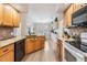 Kitchen boasts granite countertops, stainless appliances, wooden cabinets, and a large island at 4915 Fort Peck Rd, New Port Richey, FL 34655