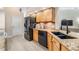 Well-equipped kitchen featuring granite countertops, a black refrigerator, and wood cabinetry at 4915 Fort Peck Rd, New Port Richey, FL 34655