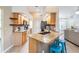 Kitchen island with granite countertops, seating, stainless appliances, and open floorplan at 4915 Fort Peck Rd, New Port Richey, FL 34655