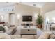 Cozy living room with a large TV, comfortable seating, and stylish decor at 4915 Fort Peck Rd, New Port Richey, FL 34655