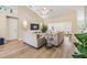 Bright and airy living room featuring vaulted ceilings, wood floors, and stylish furniture at 4915 Fort Peck Rd, New Port Richey, FL 34655