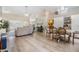 Spacious open-concept living area with modern flooring, a dining area, and comfortable seating at 4915 Fort Peck Rd, New Port Richey, FL 34655