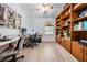 Spacious office offers ample workspace, built-in shelving, and a ceiling fan for added comfort at 4915 Fort Peck Rd, New Port Richey, FL 34655