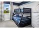 Stylish bunk beds in a cozy bedroom feature nautical-themed décor and a view to the outdoors at 5009 124Th E Ave, Parrish, FL 34219