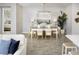 Bright dining room featuring a modern chandelier, stylish decor, and seamless integration with the living area at 5009 124Th E Ave, Parrish, FL 34219