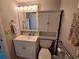 Cozy, standard-sized bathroom with a white cabinet, sink, and toilet at 5404 Springwood Blvd # 5404, Pinellas Park, FL 33782